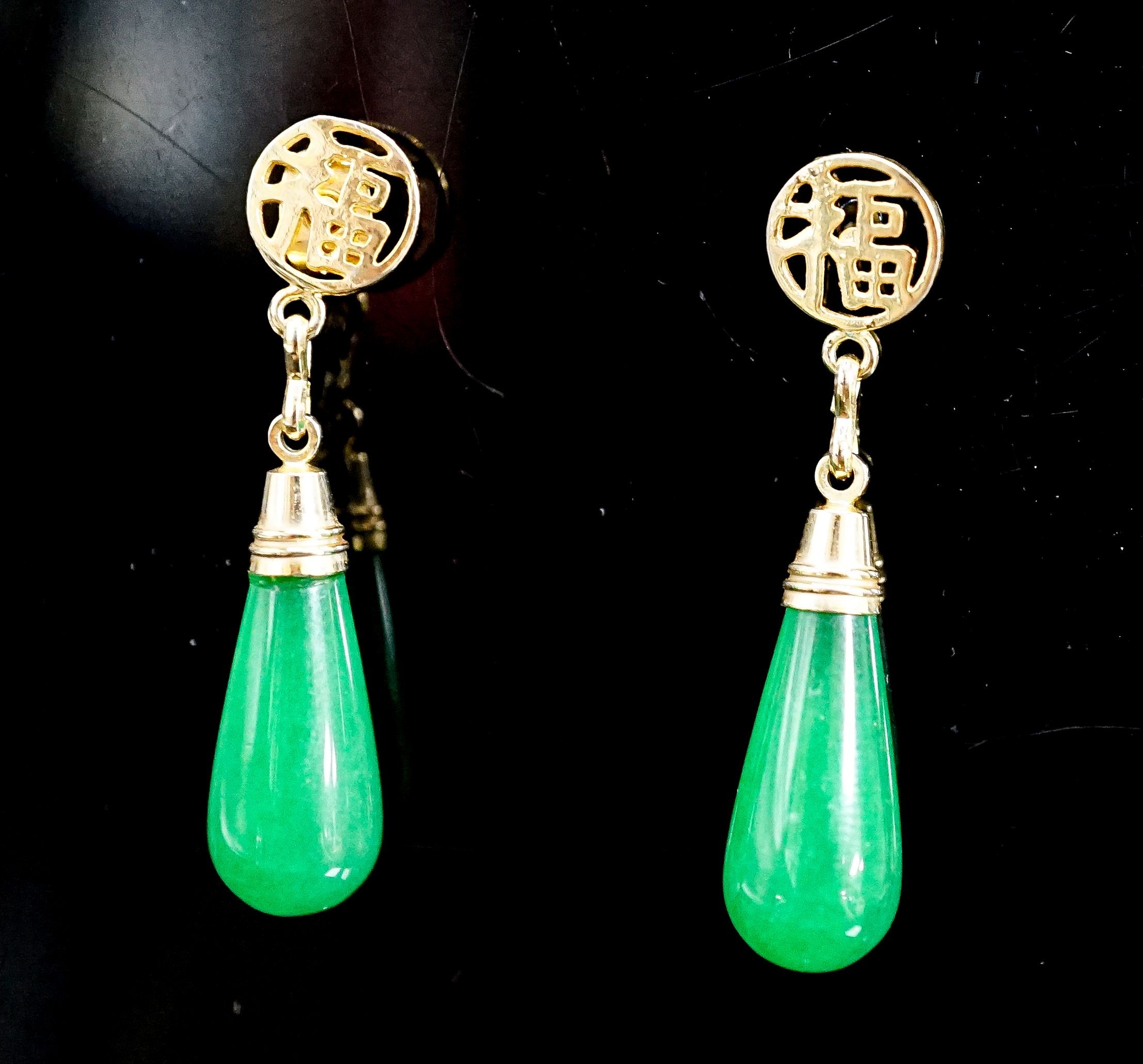A pair of Chinese yellow metal mounted teardrop shaped jade earrings, 21mm, gross weight 5.1 grams.